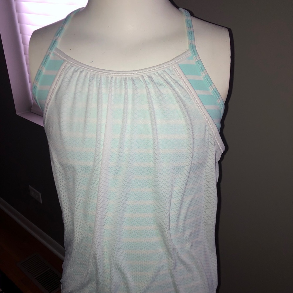 Two ivivva tanks. Girls size 10.  Includes white tank & black tank.